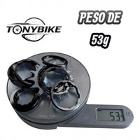 Kit de conversión single speed TONYBIKESGDL negro de 53g con corona y espaciadores sobre una báscula digital